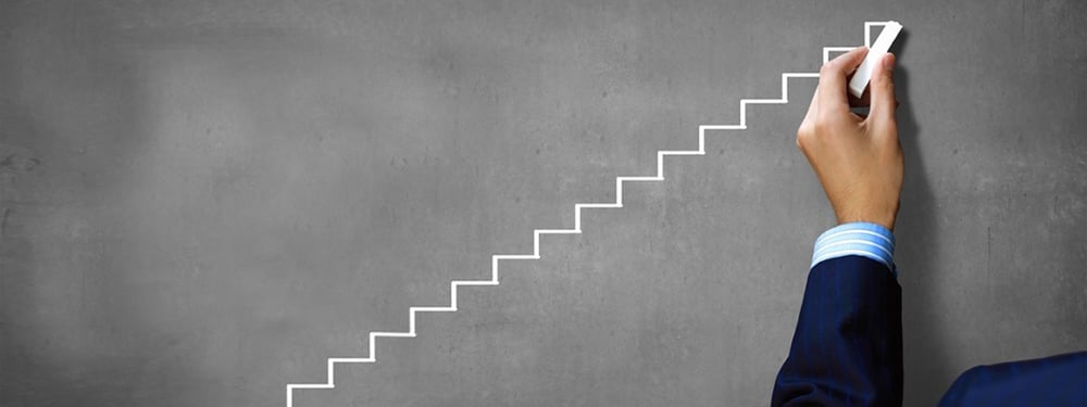 Hand drawing steps up representing incremental improvements through Kata