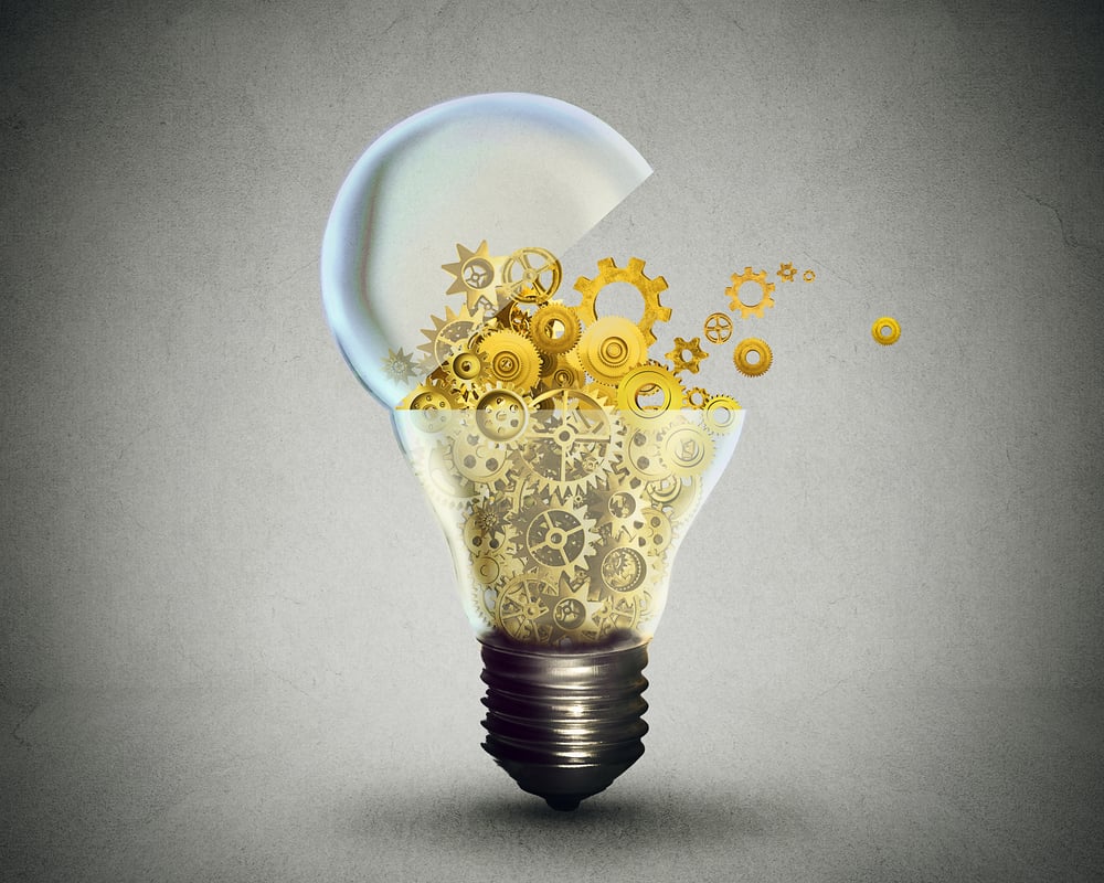 Light bulb overflowing with gears representing processes productivity improvement ideas