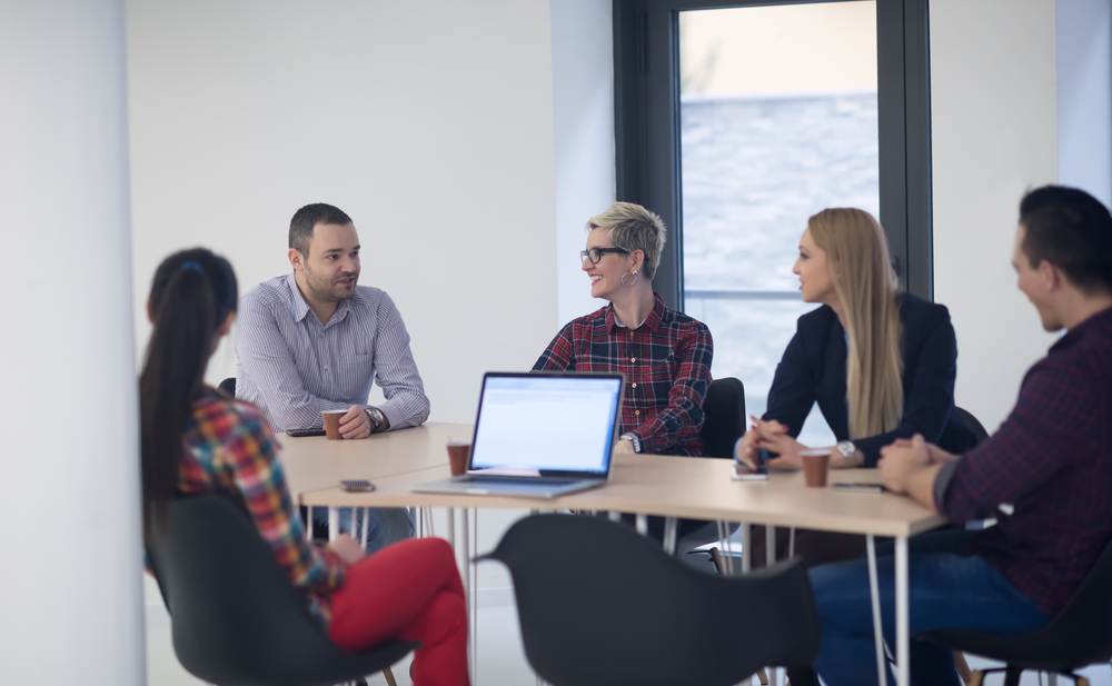 startup business team on meeting in modern bright office interior brainstorming, working on laptop and tablet computer